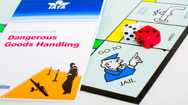 Guide on Dangerous Goods Handling alongside Monopoly 'Go to Jail' symbol, highlighting compliance in dangerous goods shipping.