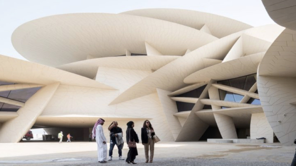 Modern architectural venue with people outside, highlighting events logistics services for transporting exhibition materials efficiently.