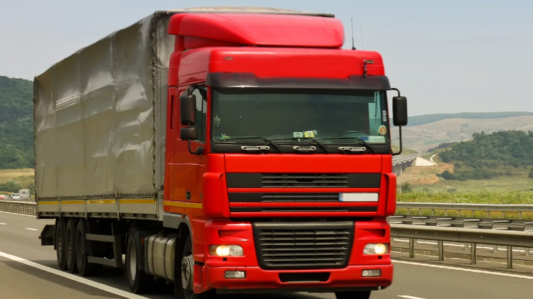 Red Truck on Highway for International Road Freight Shipping